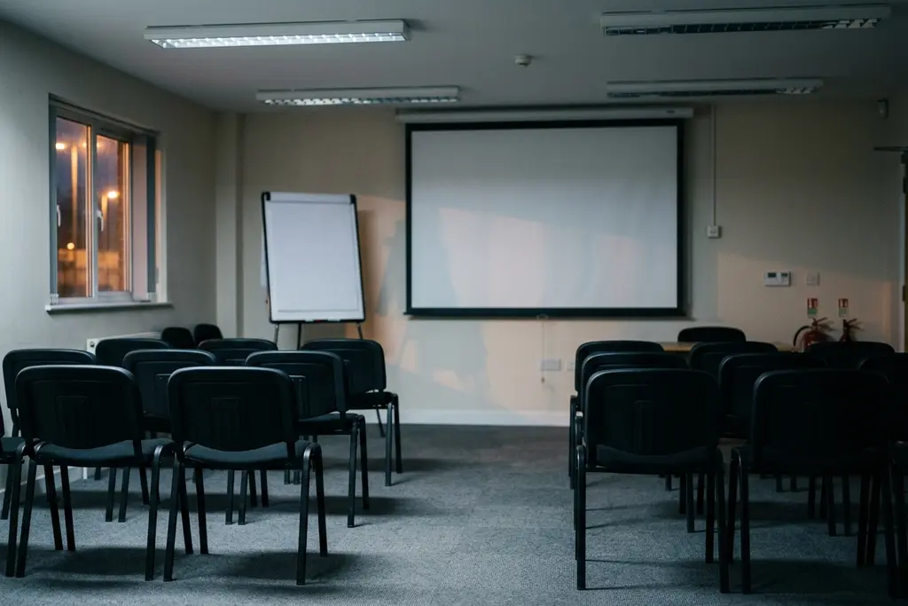 Driver CPC training room set up for periodic training, with a projector and empty chairs